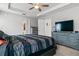 Relaxing bedroom with a ceiling fan, neutral walls, and a dresser with a television at 2053 Charleston Ln, Bartow, FL 33830