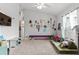 Bright playroom features carpeted floors, a large window, and comfortable seating at 2053 Charleston Ln, Bartow, FL 33830