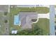 Aerial view of a house with an enclosed in-ground pool at 2645 Sw 148Th Ln, Ocala, FL 34473