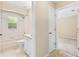 Bright bathroom with a tub and shower combination, adjacent to a bedroom at 2645 Sw 148Th Ln, Ocala, FL 34473