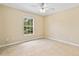 Neutral bedroom with tiled floors, ceiling fan, and a bright window at 2645 Sw 148Th Ln, Ocala, FL 34473