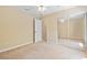 Bedroom with mirrored closet, a ceiling fan, and neutral decor at 2645 Sw 148Th Ln, Ocala, FL 34473