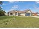Inviting single-Gathering home featuring a well-kept lawn and traditional architectural details at 2645 Sw 148Th Ln, Ocala, FL 34473