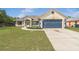 Charming single-story home with a well-manicured lawn and attached two-car garage at 2645 Sw 148Th Ln, Ocala, FL 34473