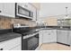 Modern kitchen features stainless steel appliances, granite countertops, and tiled backsplash at 2645 Sw 148Th Ln, Ocala, FL 34473