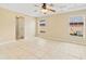 Spacious main bedroom with tray ceiling, ceiling fan, and tile flooring at 2645 Sw 148Th Ln, Ocala, FL 34473