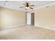 Bright main bedroom with ceiling fan and tile floors, leading to an en-suite bath at 2645 Sw 148Th Ln, Ocala, FL 34473