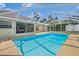 Beautiful in-ground pool within a screened enclosure, perfect for outdoor entertaining and relaxation at 2645 Sw 148Th Ln, Ocala, FL 34473