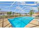 Enjoy the sparkling in-ground pool inside a screened enclosure with an expansive backyard at 2645 Sw 148Th Ln, Ocala, FL 34473