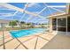 Relaxing in-ground pool with a screened enclosure, featuring a large patio for seating and entertaining at 2645 Sw 148Th Ln, Ocala, FL 34473