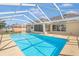 Relax in the private in-ground pool with a screened enclosure and sunny patio area at 2645 Sw 148Th Ln, Ocala, FL 34473