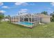 A partially-covered in-ground pool in the backyard at 2645 Sw 148Th Ln, Ocala, FL 34473