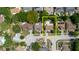 Aerial view of a home with a backyard pool highlighted in yellow; surrounded by trees, neighboring houses, and streets at 7072 Scruboak Ln, Orlando, FL 32818