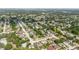 Wide aerial view of a residential neighborhood with an arrow, indicating the location of a home among green landscapes at 7072 Scruboak Ln, Orlando, FL 32818