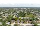 Aerial view showcases a home with an arrow, highlighting its location in a residential neighborhood with lush trees at 7072 Scruboak Ln, Orlando, FL 32818