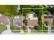 Aerial view of a home within a yellow outlined property, featuring a pool, surrounded by trees and streets at 7072 Scruboak Ln, Orlando, FL 32818