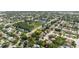Aerial view of a residential neighborhood with an arrow indicating a home's location among tree-lined streets at 7072 Scruboak Ln, Orlando, FL 32818