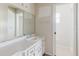 This bathroom features a single sink vanity and a mirror with Hollywood-style lighting at 7072 Scruboak Ln, Orlando, FL 32818