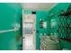 Colorful bathroom with tiled shower, sink, and decorated shelves at 7072 Scruboak Ln, Orlando, FL 32818