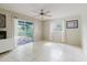 Bright bedroom with tile flooring, ceiling fan, and a screened-in patio at 7072 Scruboak Ln, Orlando, FL 32818