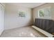 This bedroom features neutral colored walls, carpeted floors, and two windows providing natural light at 7072 Scruboak Ln, Orlando, FL 32818