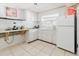 Bright kitchen with white cabinets, tile floors, and a window providing natural light at 7072 Scruboak Ln, Orlando, FL 32818
