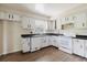 Bright kitchen with white cabinets, laminate counters, and white appliances at 7072 Scruboak Ln, Orlando, FL 32818