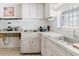 Cozy kitchen featuring white cabinetry, tile floors, and functional countertops at 7072 Scruboak Ln, Orlando, FL 32818