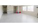 Open living area with gray floors, banister and a view into the dining room at 7072 Scruboak Ln, Orlando, FL 32818