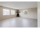 Spacious living room featuring tile floors, three windows, and natural light at 7072 Scruboak Ln, Orlando, FL 32818