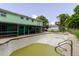 Backyard featuring a pool with algae and an upper deck on a two-story home with a screened-in patio at 7072 Scruboak Ln, Orlando, FL 32818