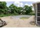 Backyard view of an in-ground pool surrounded by lush greenery and concrete patio at 7072 Scruboak Ln, Orlando, FL 32818