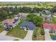 Beautiful aerial view of a home with a lush green lawn, mature trees, and a long driveway leading to an attached garage at 1003 Edmund Ave, Dundee, FL 33838