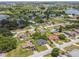 Expansive aerial view of a residential area featuring well-maintained homes, verdant lawns, and close proximity to a lake at 1003 Edmund Ave, Dundee, FL 33838