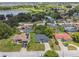 Aerial view of a single-story home with well-manicured lawn in a lakeside community at 1003 Edmund Ave, Dundee, FL 33838