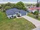 Aerial view of a single-story home featuring a well-manicured front lawn and a two car garage at 1003 Edmund Ave, Dundee, FL 33838