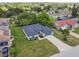 Aerial view of a single-story home featuring a well-manicured front lawn and a two car garage at 1003 Edmund Ave, Dundee, FL 33838