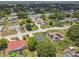 The aerial view shows a neighborhood with tree-lined streets and various home styles at 1003 Edmund Ave, Dundee, FL 33838