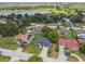Aerial view of a single-story home with well-manicured lawn in a lakeside community at 1003 Edmund Ave, Dundee, FL 33838