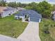 An aerial view of a lovely single-story home on a well-manicured lawn with an extended driveway at 1003 Edmund Ave, Dundee, FL 33838