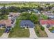 Aerial view of a single-story home with well-manicured lawn in a lakeside community at 1003 Edmund Ave, Dundee, FL 33838