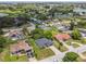 This aerial shot highlights a residential neighborhood with manicured lawns, mature trees, and nearby community parkland at 1003 Edmund Ave, Dundee, FL 33838