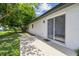 Home's backyard featuring a covered patio and lawn at 1003 Edmund Ave, Dundee, FL 33838
