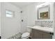 Stylish bathroom features elegant fixtures, modern vanity, and walk-in shower at 1003 Edmund Ave, Dundee, FL 33838