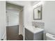 Bathroom featuring a gray vanity with gray backsplash and access to other rooms in the house at 1003 Edmund Ave, Dundee, FL 33838