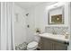 Nicely remodeled bathroom with patterned tile floor in shower, vanity with tile backsplash at 1003 Edmund Ave, Dundee, FL 33838