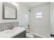 Updated bathroom features stylish vanity with elegant fixtures and a shower-tub combo with white tiling at 1003 Edmund Ave, Dundee, FL 33838