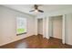 Bedroom with wood floors, ceiling fan, a window, and closet with folding doors at 1003 Edmund Ave, Dundee, FL 33838