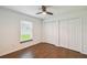 Bright bedroom featuring tile floors, two closets and a window with natural light at 1003 Edmund Ave, Dundee, FL 33838