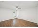 This bedroom features wood-look floors, a ceiling fan, and a window providing natural light at 1003 Edmund Ave, Dundee, FL 33838
